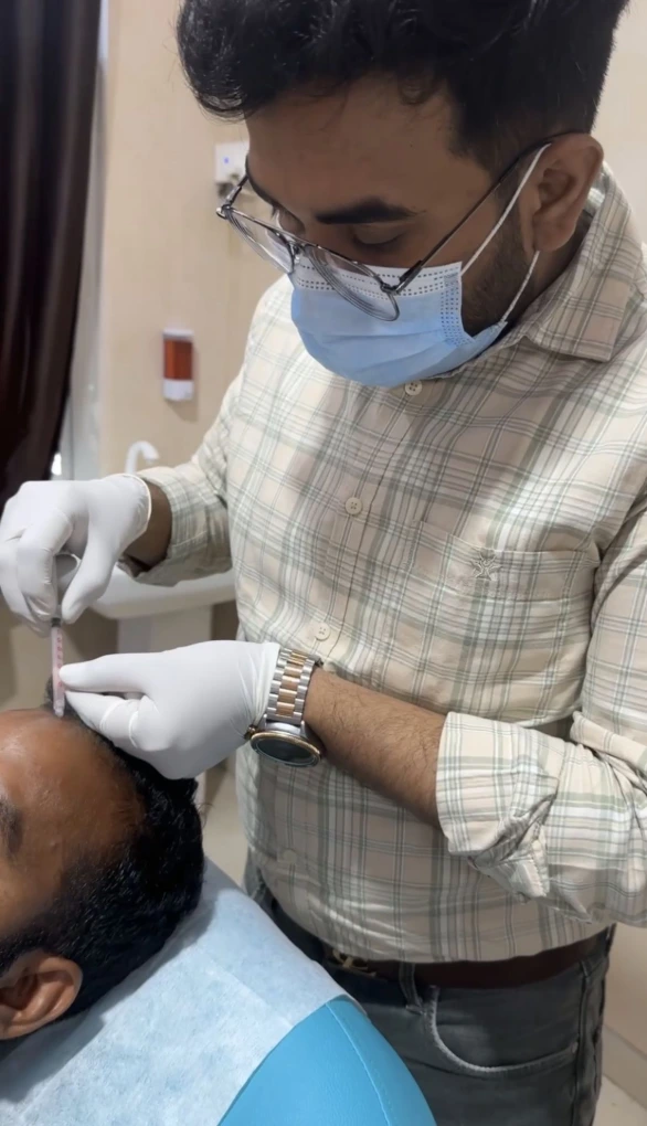 Dr Usama Siddiqui performing hair assessment in Raebareli